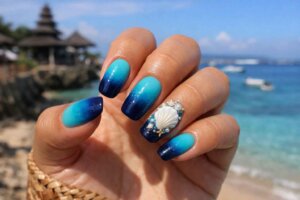 Bali nails blue design inspiration featuring turquoise to navy gradient with 3D resin seashell nail art