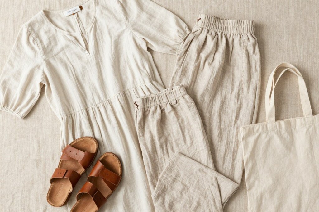 High-quality sustainable vacation wardrobe pieces laid out